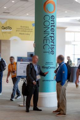 Tall pillar banner applying the InformaTech brand refresh at an in-person event